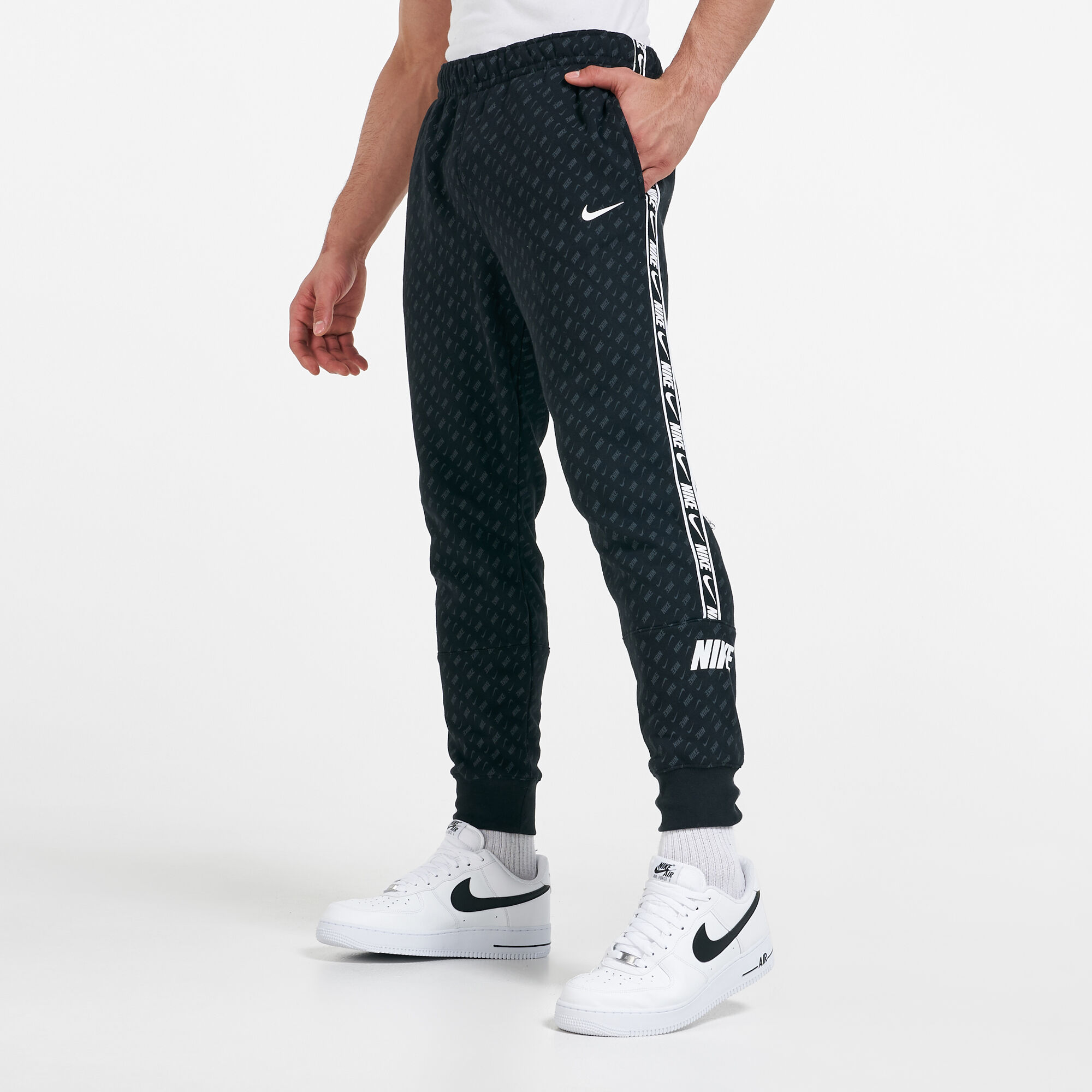 Nike repeat print track pants deals