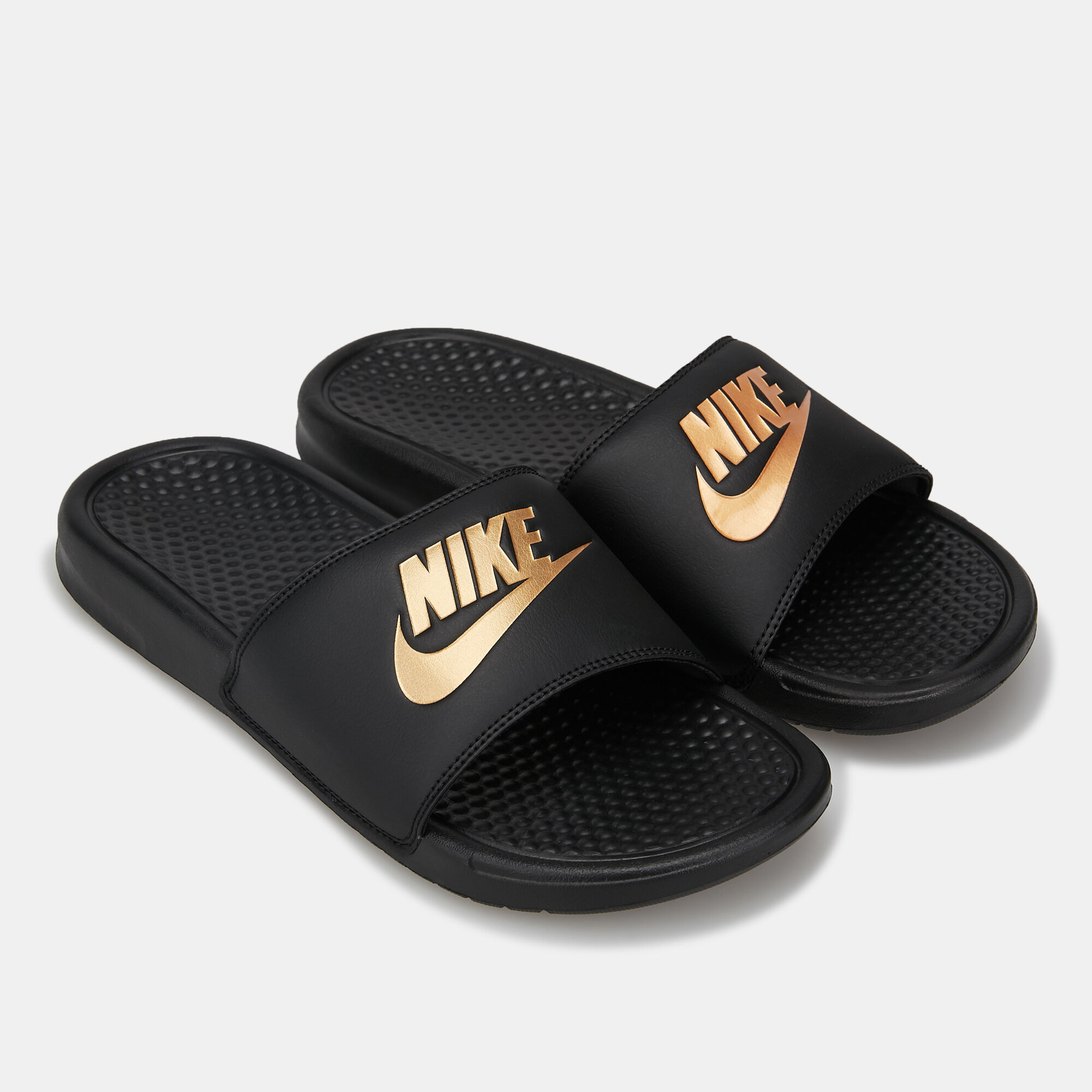 Black nike slides with gold swoosh top