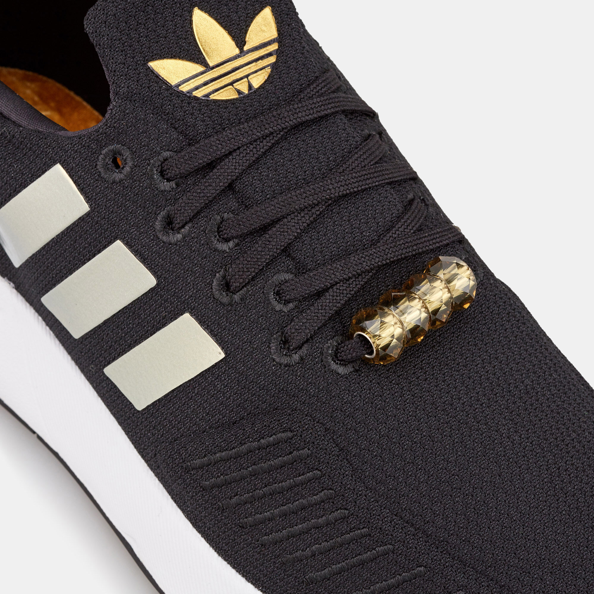 Women's swift run black and gold best sale